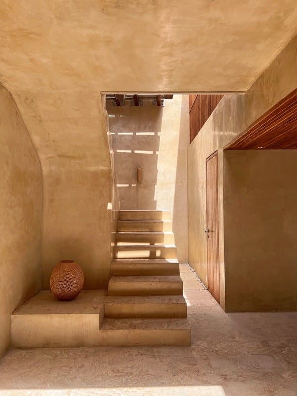 Sculpted stairs lead up through the house.