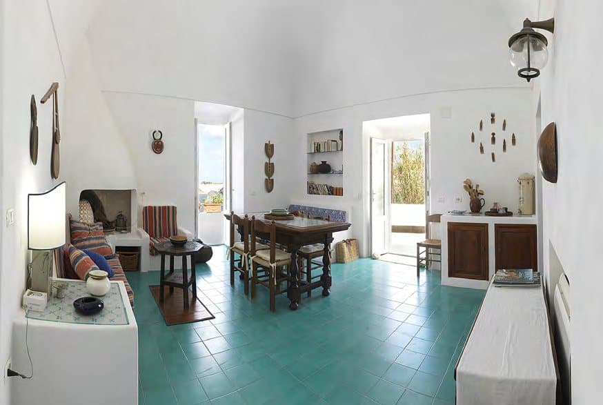 Living and dining in the main house, on turquoise island tiles.