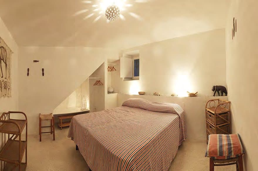 Soft evening light in a domed double bedroom.
